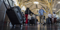 Passengers with suitcases.