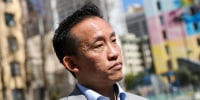 David Chiu stands outside